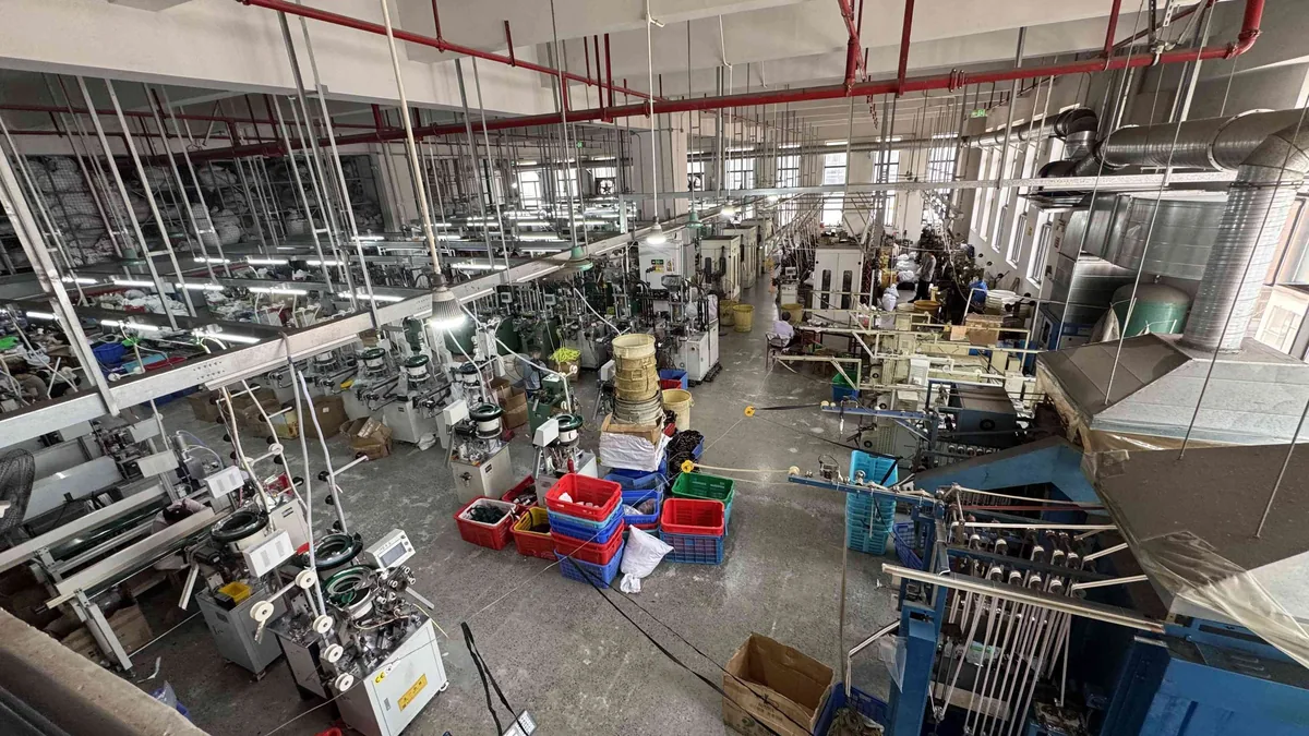 CEO Zipper factory floor with multiple zipper production lines in operation